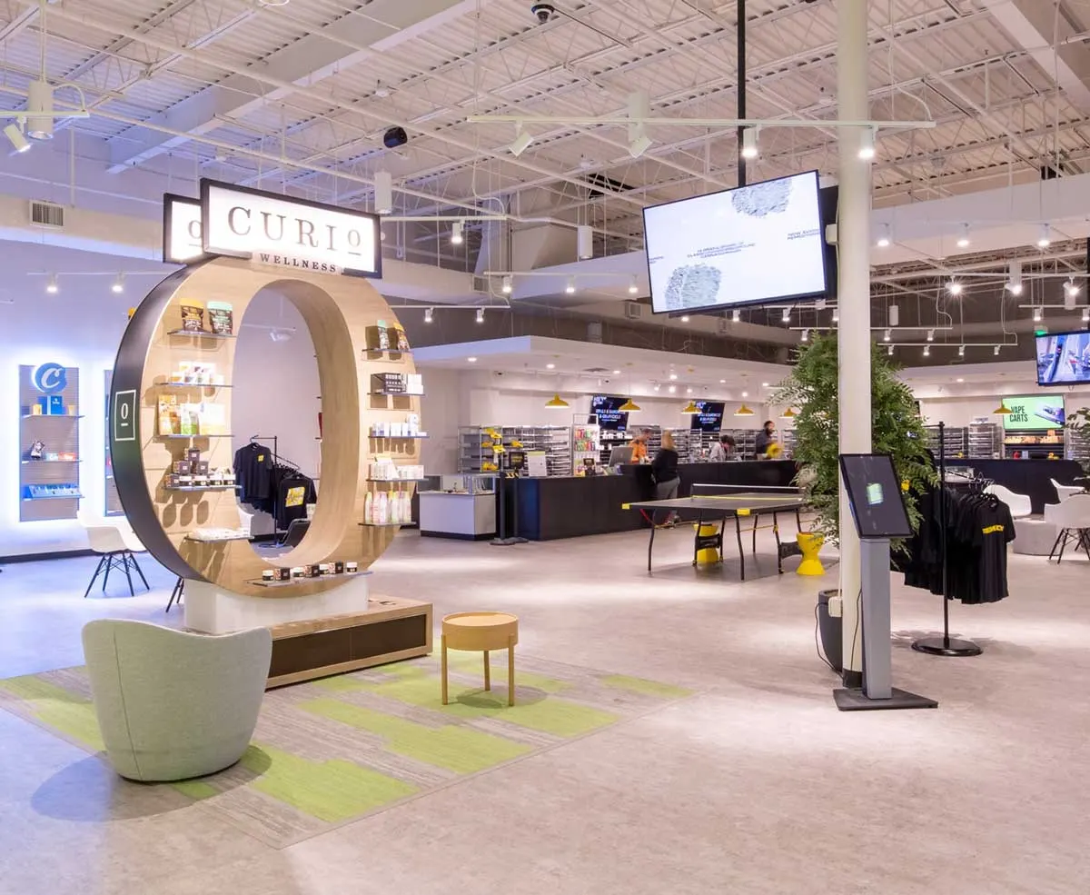 Spacious dispensary showroom with circular Curio product display and seating